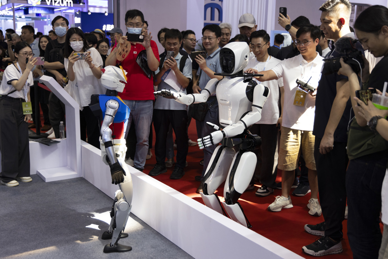 The World Robot Conference opens, with 27 humanoid robots